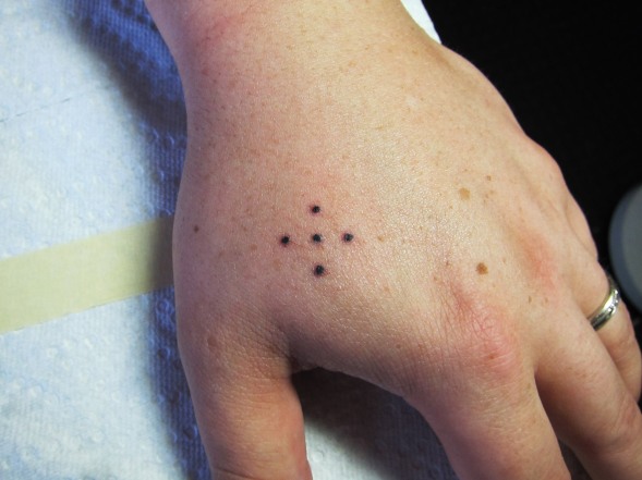 What do four dot tattoos on the hand signify?
